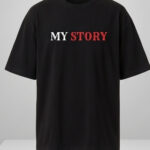 Man wearing a black oversized streetwear T-shirt with 'Scary Story' printed on the back in white and red text.