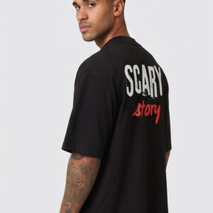 Man wearing a black oversized streetwear T-shirt with 'Scary Story' printed on the back in white and red text.