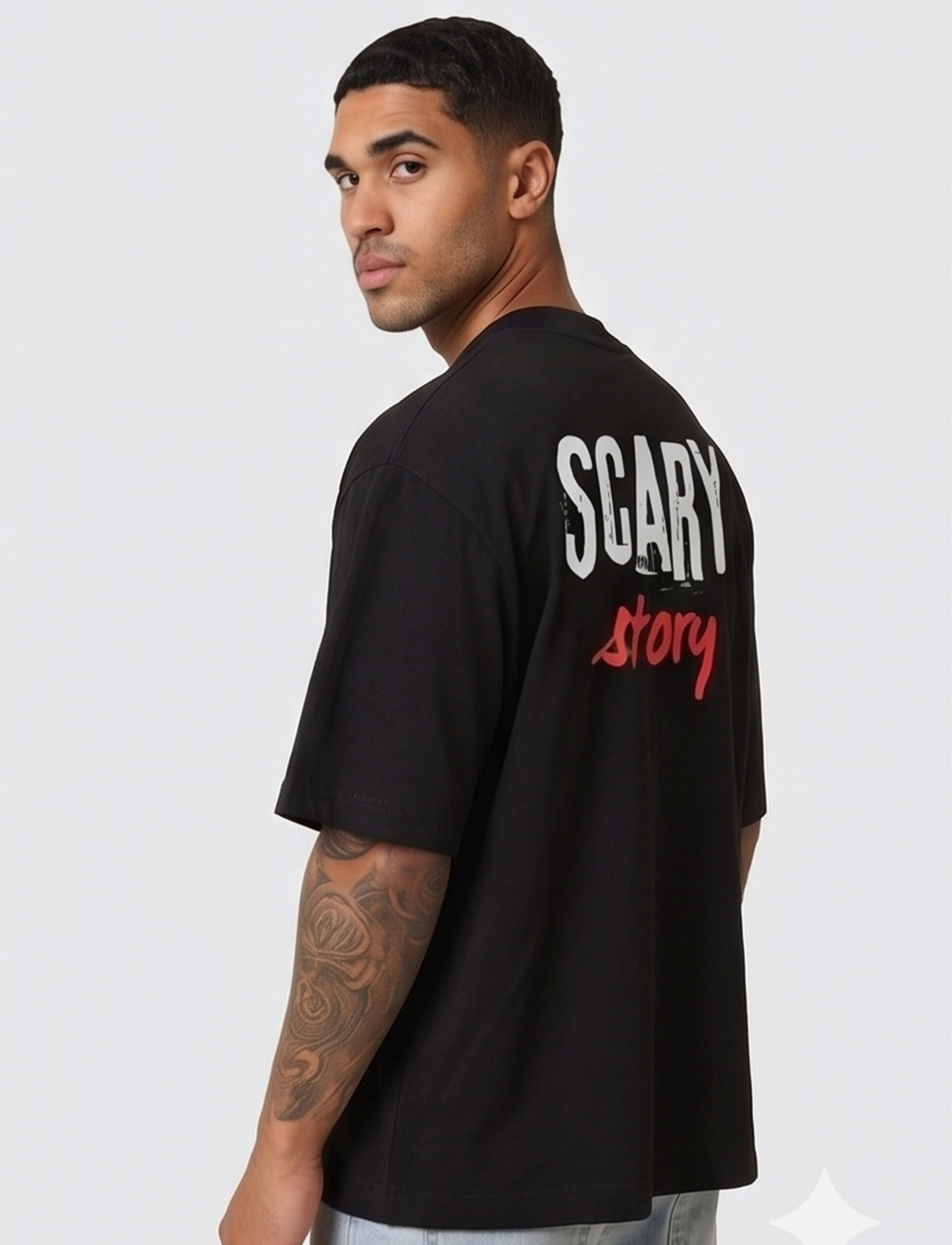 Man wearing a black oversized streetwear T-shirt with 'Scary Story' printed on the back in white and red text.