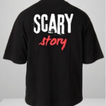 Man wearing a black oversized streetwear T-shirt with 'Scary Story' printed on the back in white and red text.