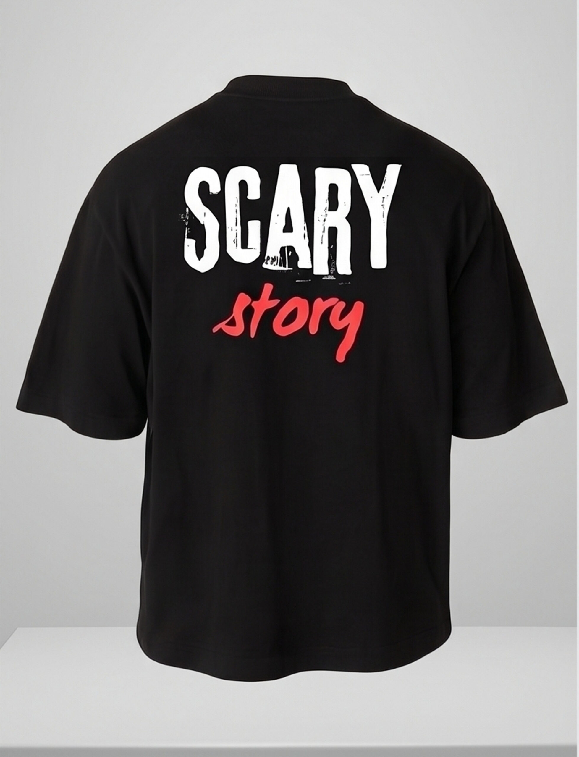 Man wearing a black oversized streetwear T-shirt with 'Scary Story' printed on the back in white and red text.